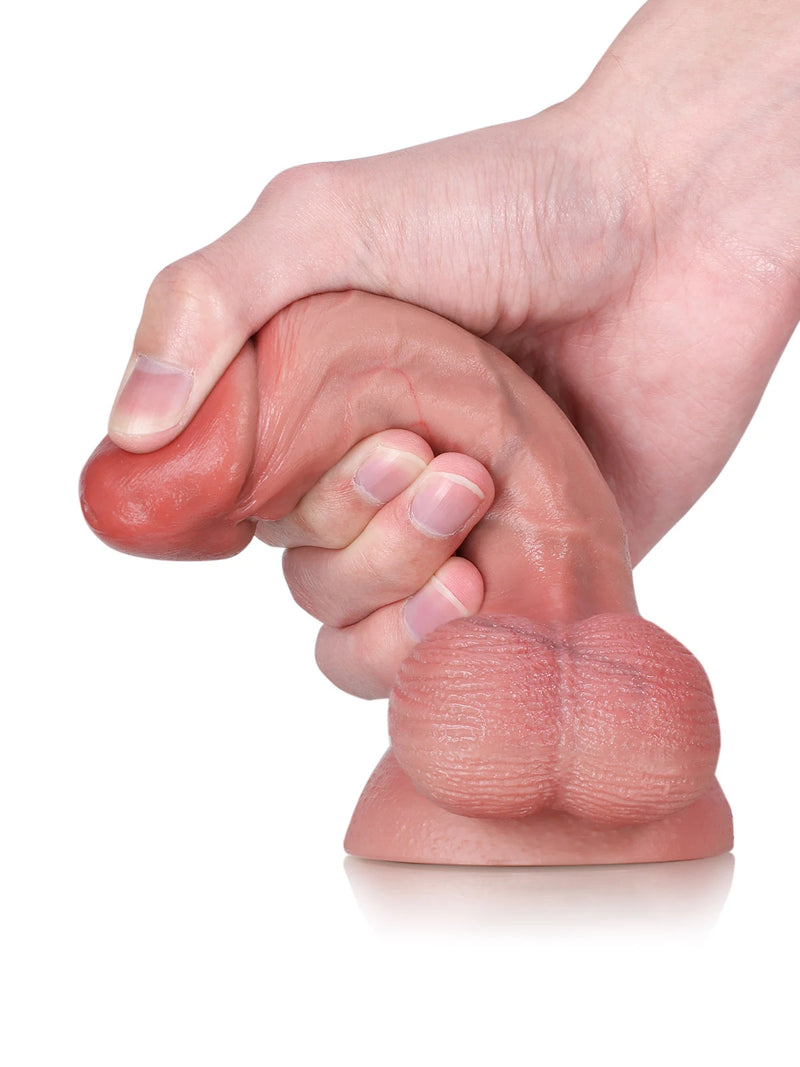Finger squeezing Bayou soft cone-shaped glans to show its gentle give