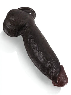 Black dildo on its suction cup base for hands-free play