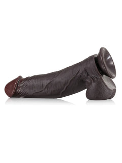 Black real-skin dildo lying on its suction base for hands-free play