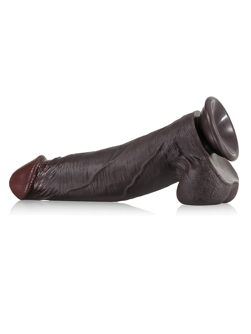 Black real-skin dildo lying on its suction base for hands-free play