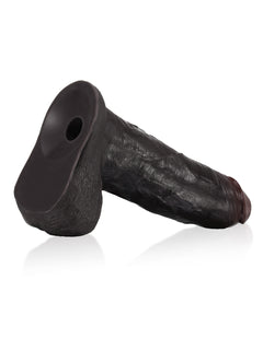 Black sliding skin dildo lying on its Vac-U-Lock suction base