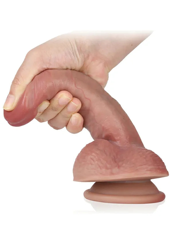 Compact beginner flesh dildo held in hand showing its easy-to-control size
