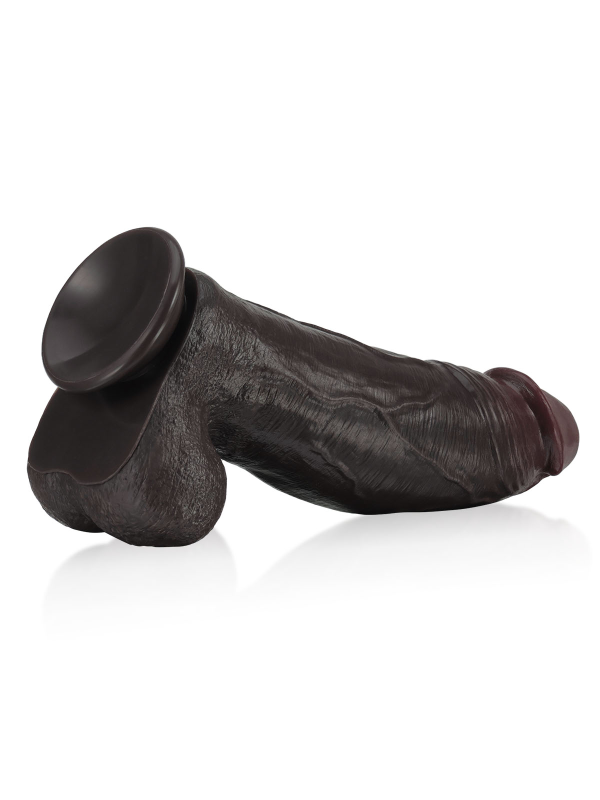 Extra-huge black dildo with a strong suction base, lying side view