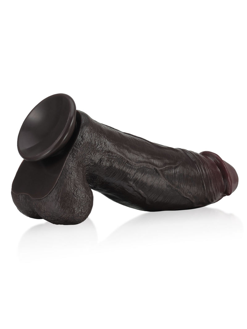 Extra-huge black dildo with a strong suction base, lying side view