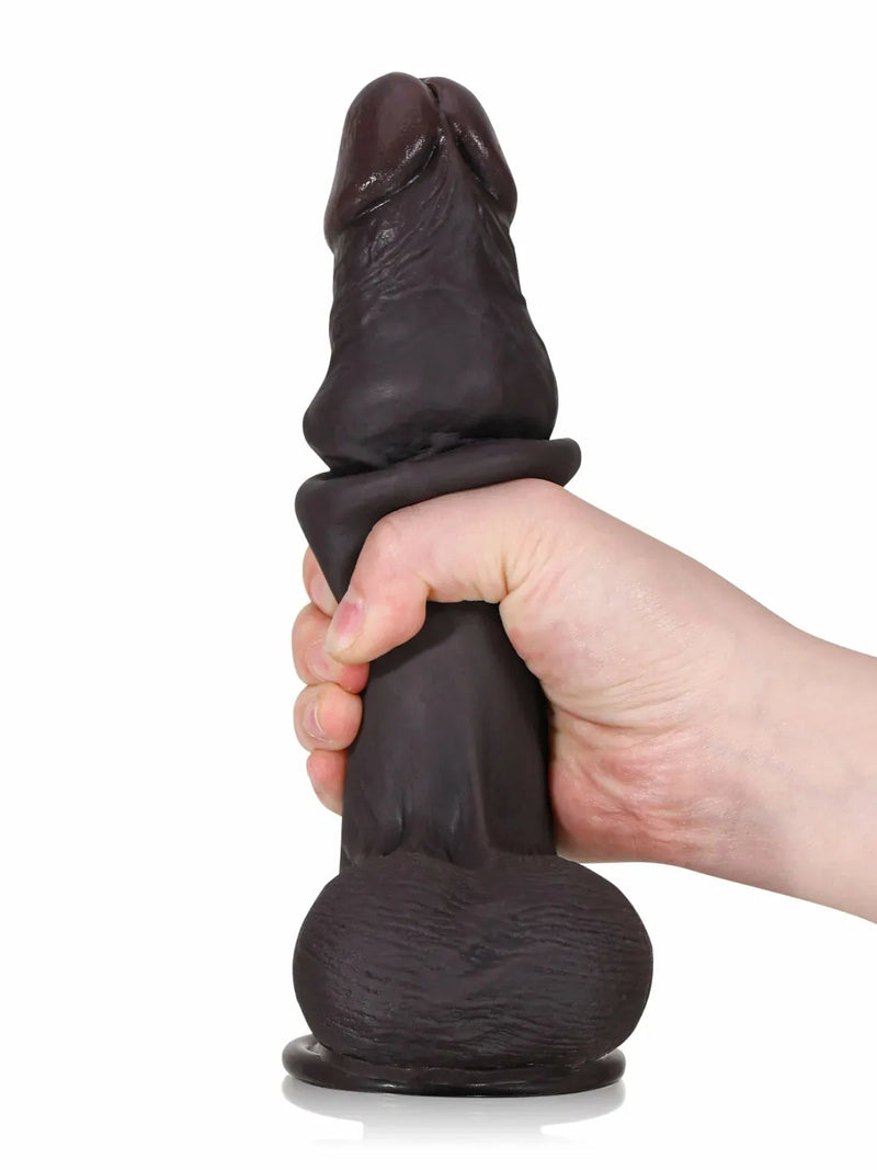 Hand holding black cyberskin dildo to show realistic size