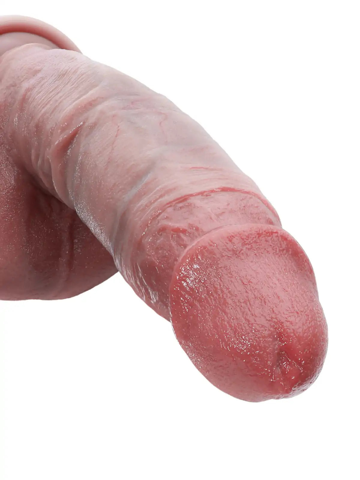 Close-up of realistic dildo head and shaft showing soft glans and lifelike skin texture