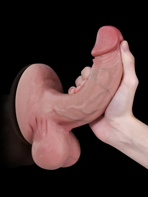 Realistic flesh suction cup dildo held in hand, dark background
