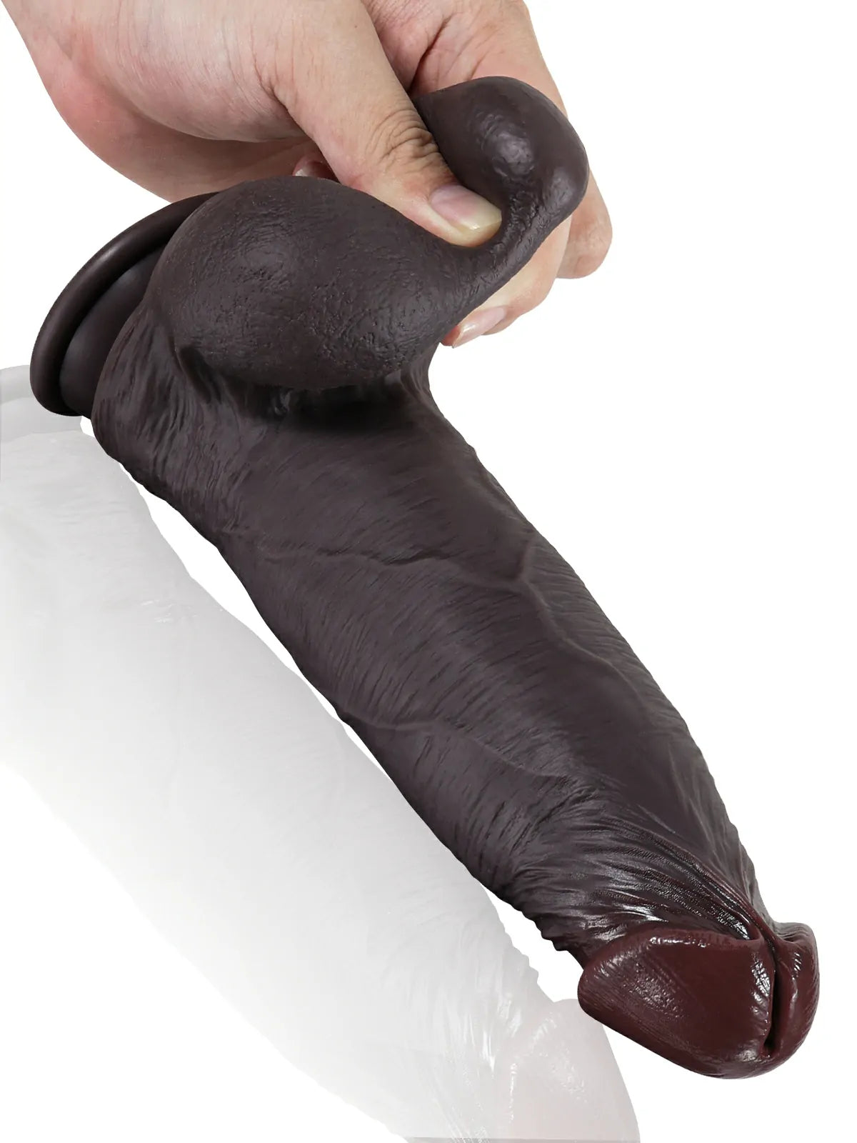 Hands stretching the sliding skin on a black realistic dildo