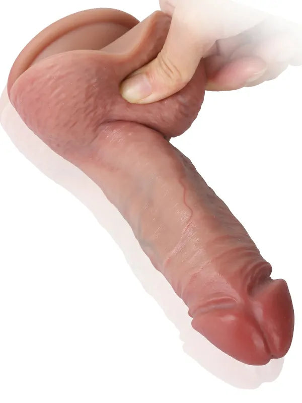 Hand squeezing the soft dual-density flesh dildo to show its real-flesh give